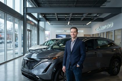 Un homme en blazer marine admire un SUV Nissan dans une concession automobile moderne aux sols en béton poli